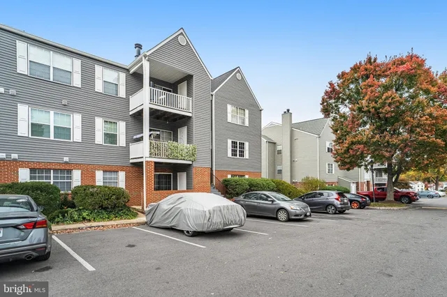 a couple of cars parked in front of a building