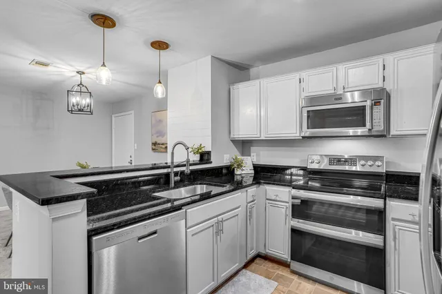 a kitchen with a sink stove and microwave