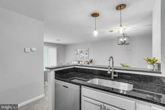 a kitchen with a sink and chandelier