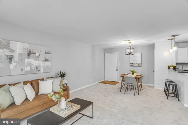 a living room with furniture and a dining table