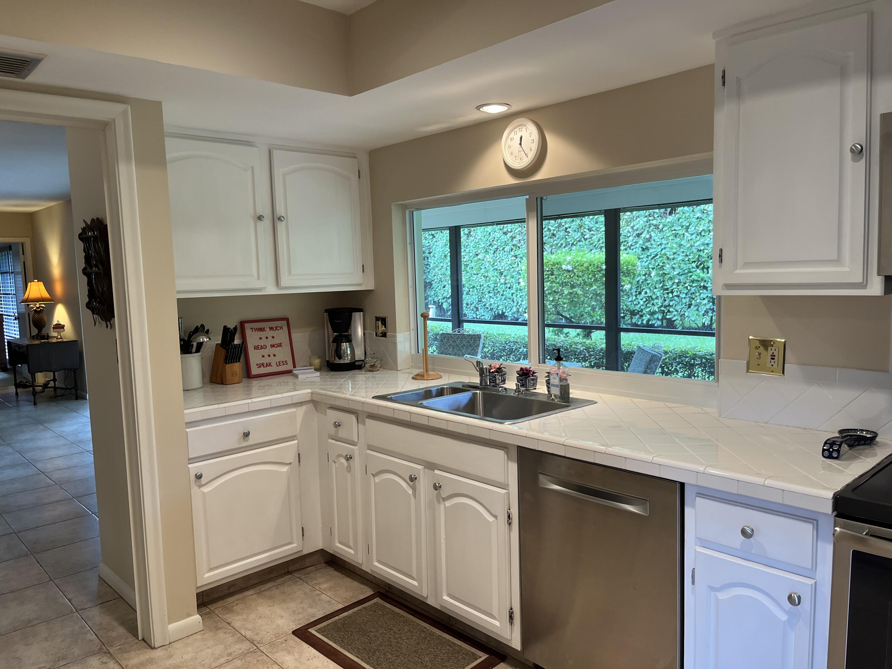 493 Forestview Drive Atlantis, FL 33462 - Photo 14 of 21 a kitchen with a sink and cabinets