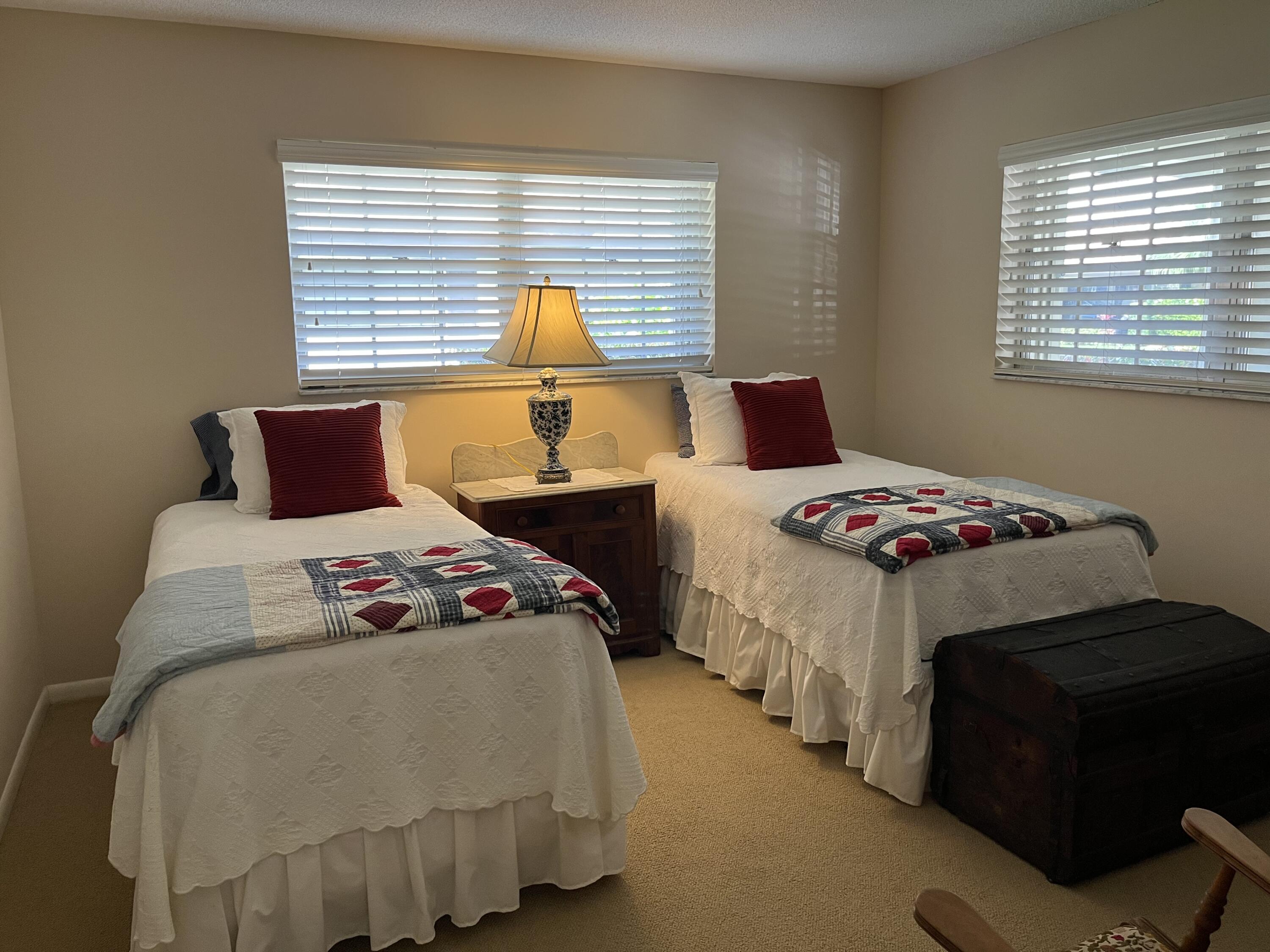 493 Forestview Drive Atlantis, FL 33462 - Photo 17 of 21 a bedroom with two beds and a window