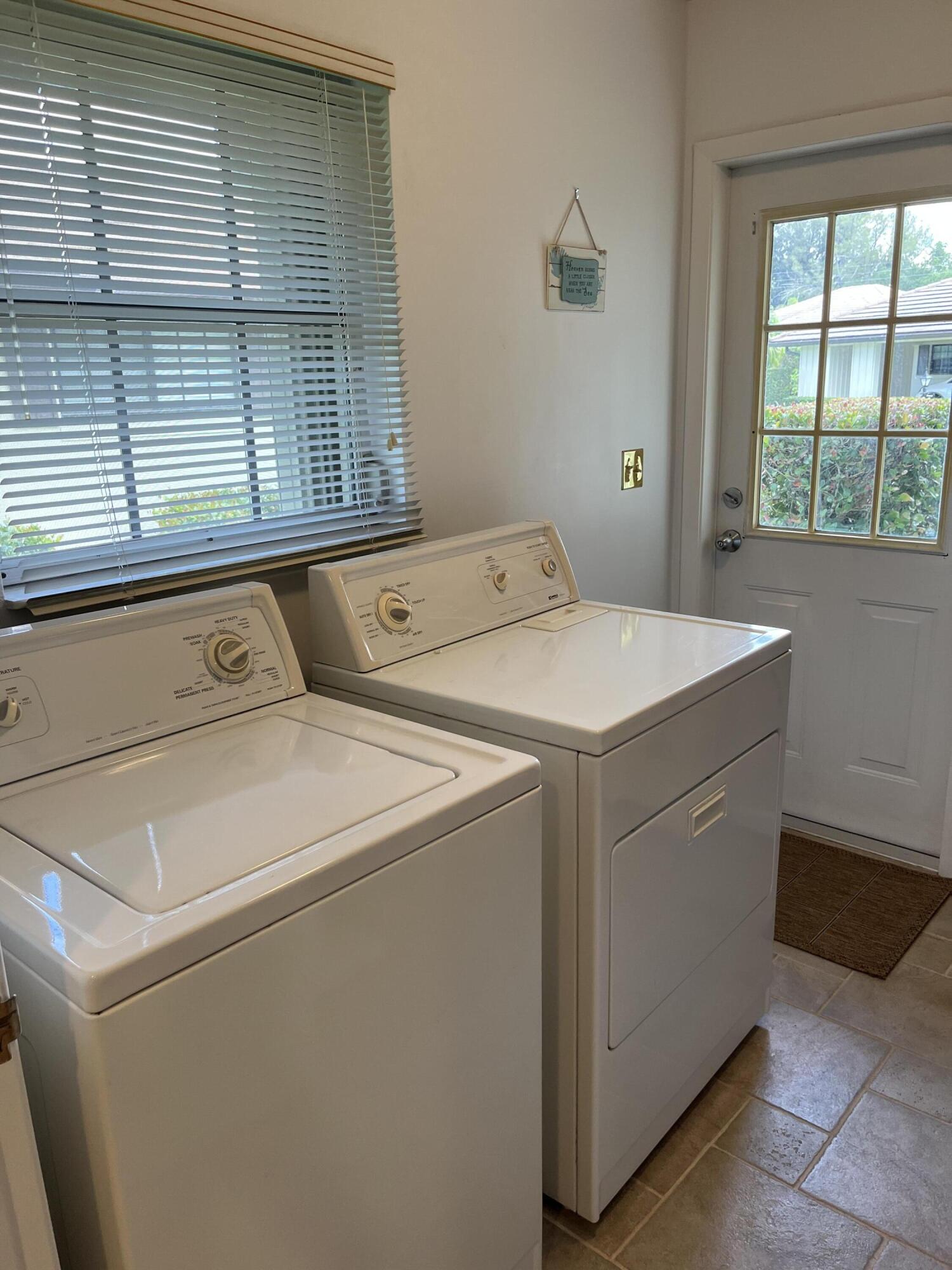 493 Forestview Drive Atlantis, FL 33462 - Photo 21 of 21 a utility room with dryer and washer