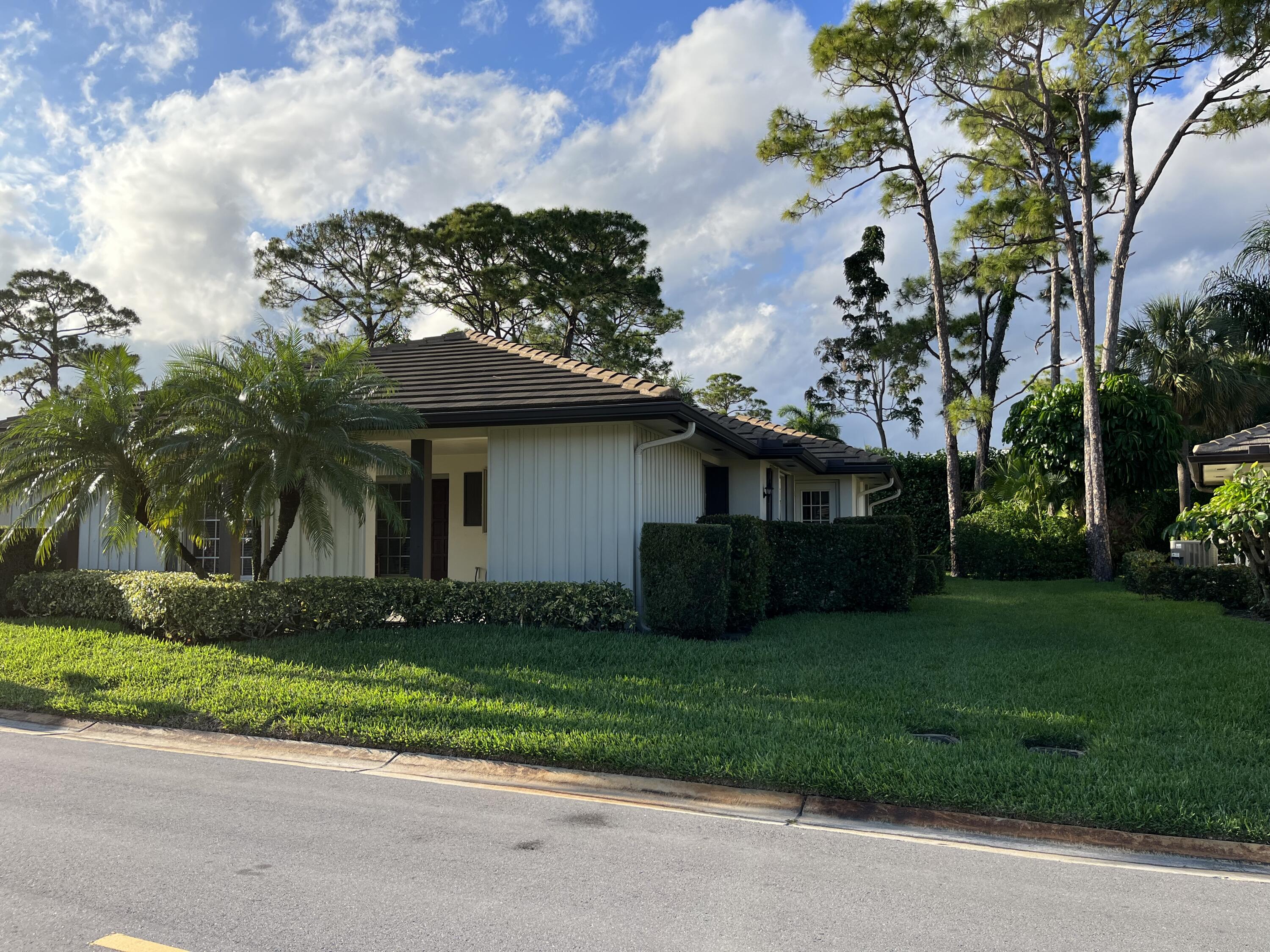 493 Forestview Drive Atlantis, FL 33462 - Photo 5 of 21 a front view of a house with garden