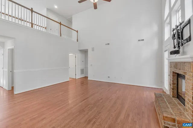 a spacious bathroom with a granite countertop sink a toilet and a mirror