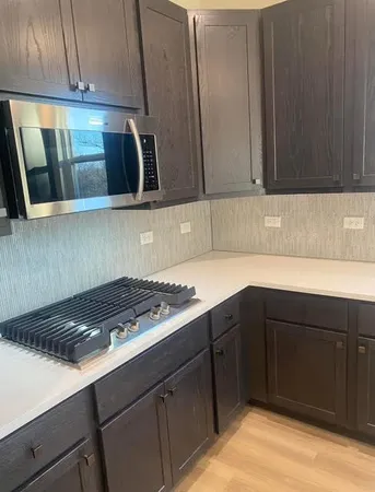 a kitchen with cabinets and stainless steel appliances