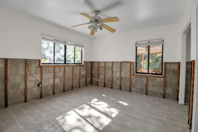 an empty room with windows and closet