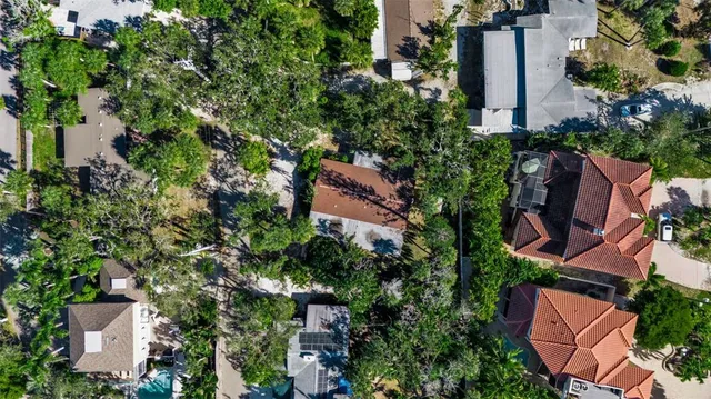 an aerial view of a house with garden space and street view