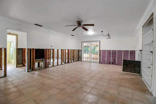 a view of an empty room with fireplace and a window