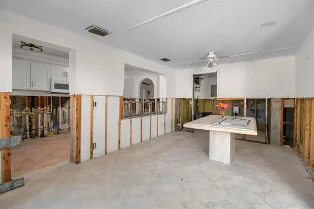 a view of kitchen with furniture and refrigerator