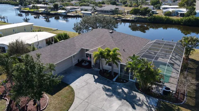 an aerial view of a house with outdoor space and lake view