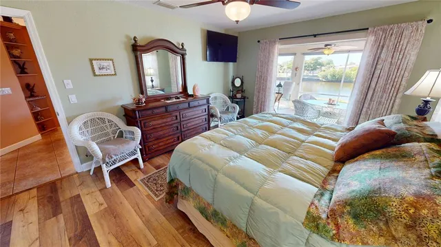 a bedroom with a bed window and a mirror