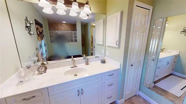 a bathroom with a sink double vanity and a mirror