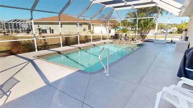 a view of a patio with a table and chairs under an umbrella