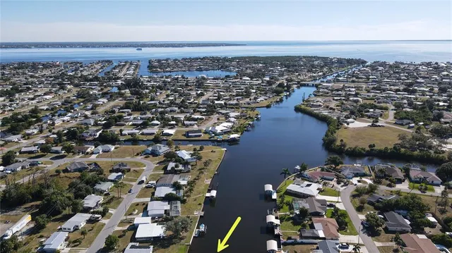 an aerial view of a house with a yard and a fountain