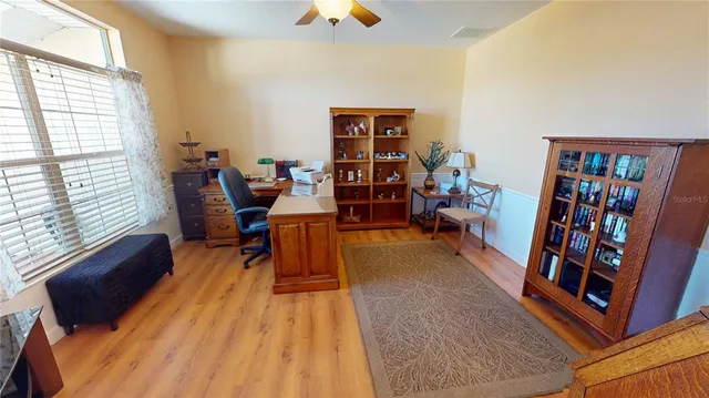 a living room with furniture and a book shelf