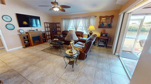 a living room with furniture a flat screen tv and a window