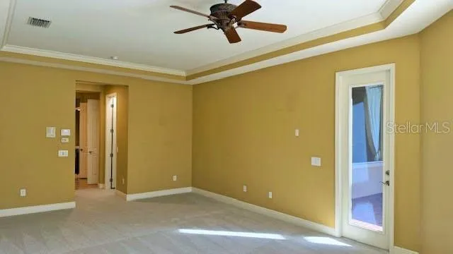 a view of an empty room with a ceiling fan