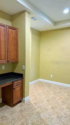 a view of a kitchen with wooden floor and a sink