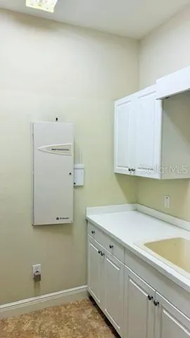 a room with a sink and cabinets