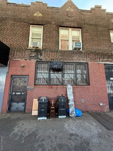 a view of a brick house with many windows