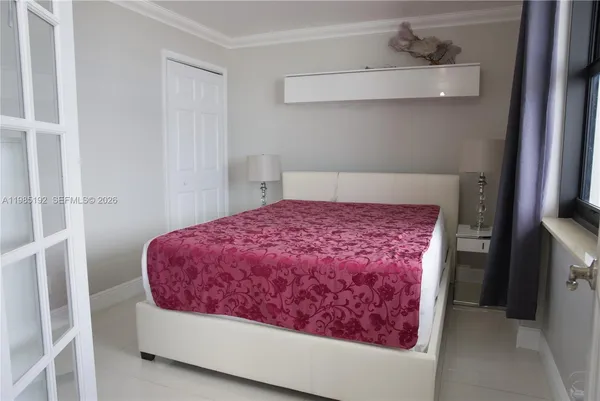 a bed room with a bed and chair