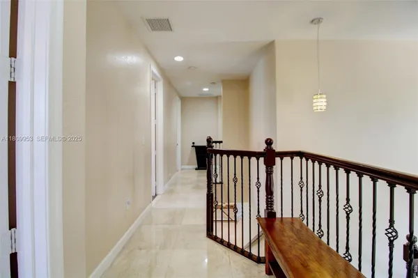a view of a hallway with entryway door
