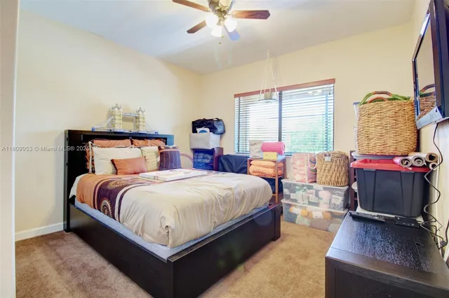a spacious bedroom with a bed couch and a window