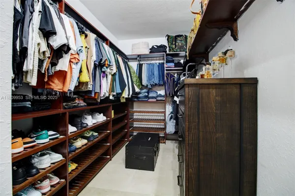 a living room with furniture a potted plant and a sink