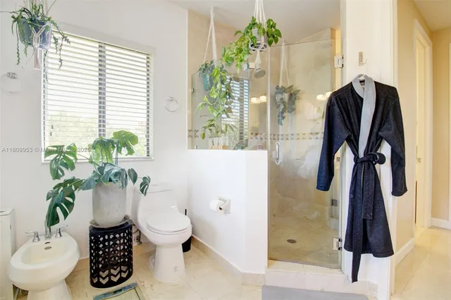 a white bath tub sitting in a bathroom next to a window