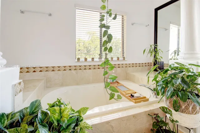 a bathroom with a sink a mirror and a shower
