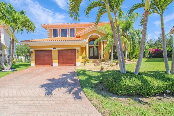 a front view of a house with a garden