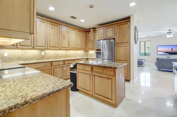 a kitchen with stainless steel appliances granite countertop a stove sink and cabinets