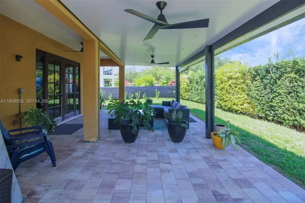 a view of a house with a yard and sitting area