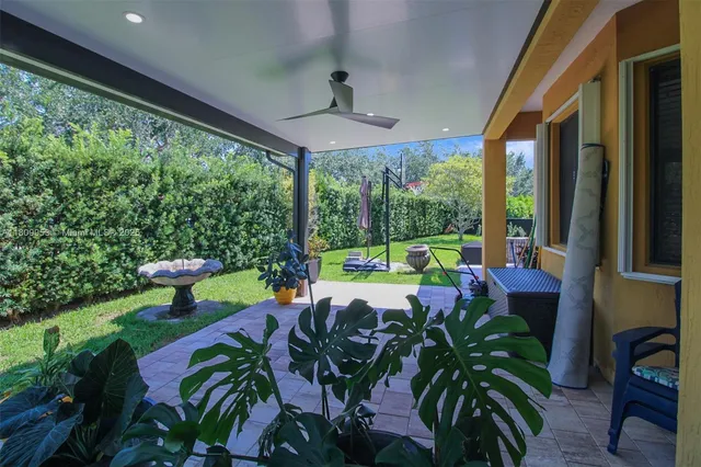 a front view of a house with a yard and potted plants
