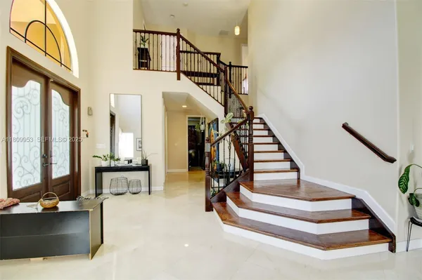a view of entryway and hall with wooden floor