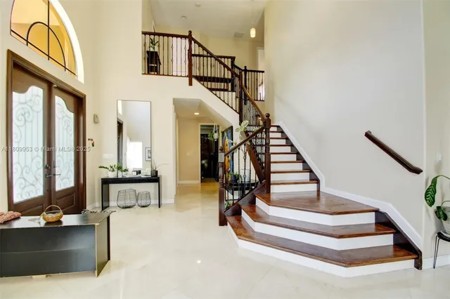 a view of entryway and hall with wooden floor