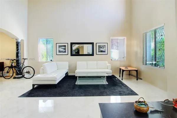 a view of living room filled with furniture and a potted plant