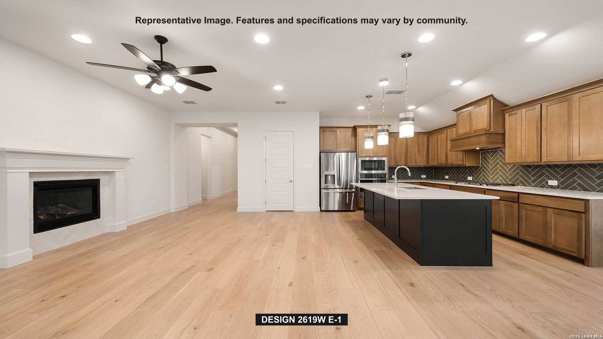 323 Bella Rosa Way Cibolo, TX 78108 - Photo 5 of 15 a large kitchen with kitchen island a sink stainless steel appliances and cabinets