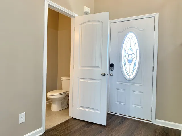 a bathroom with a toilet a sink and a mirror