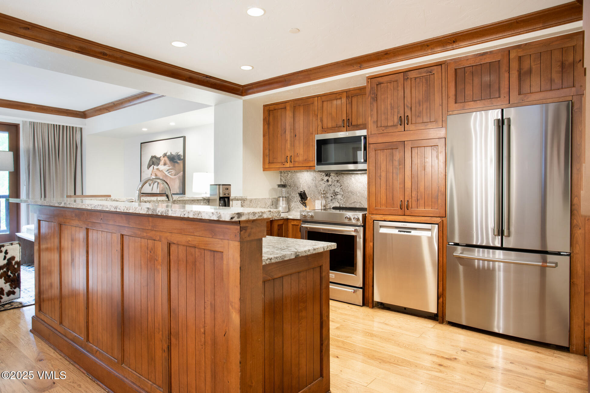 100 Bachelor Ridge Road, Unit 3314 Avon, CO 81620 - Photo 6 of 58 a kitchen with stainless steel appliances granite countertop a refrigerator a stove and a sink with wooden floor