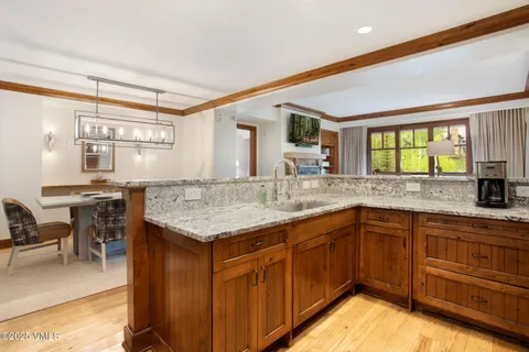 a kitchen with granite countertop a refrigerator and a sink