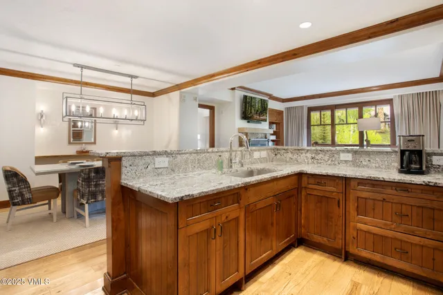 a kitchen with granite countertop a refrigerator and a sink
