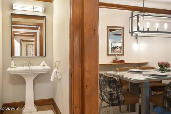 a bedroom with a large bed and a lamp on table