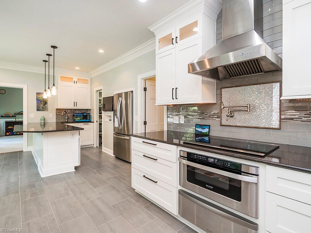 5001 Leadenhall Road Oak Ridge, NC 27310 - Photo 7 of 30 Beautiful updated kitchen with tile floor/backsplash, convection oven, electronic induction countertop stove with pot filler!