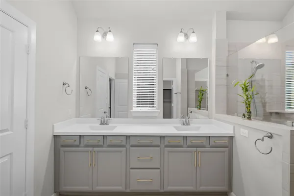 a bathroom with a double vanity sink mirror and double