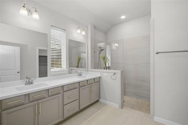 a bathroom with a double vanity sink and a mirror