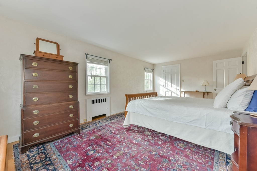460 Brook Road Milton, MA 02186 - Photo 11 of 14 a spacious bedroom with a bed and a window