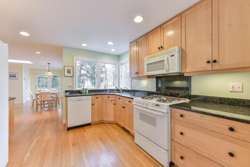 460 Brook Road Milton, MA 02186 - Photo 3 of 14 a kitchen with granite countertop wooden floors appliances and cabinets
