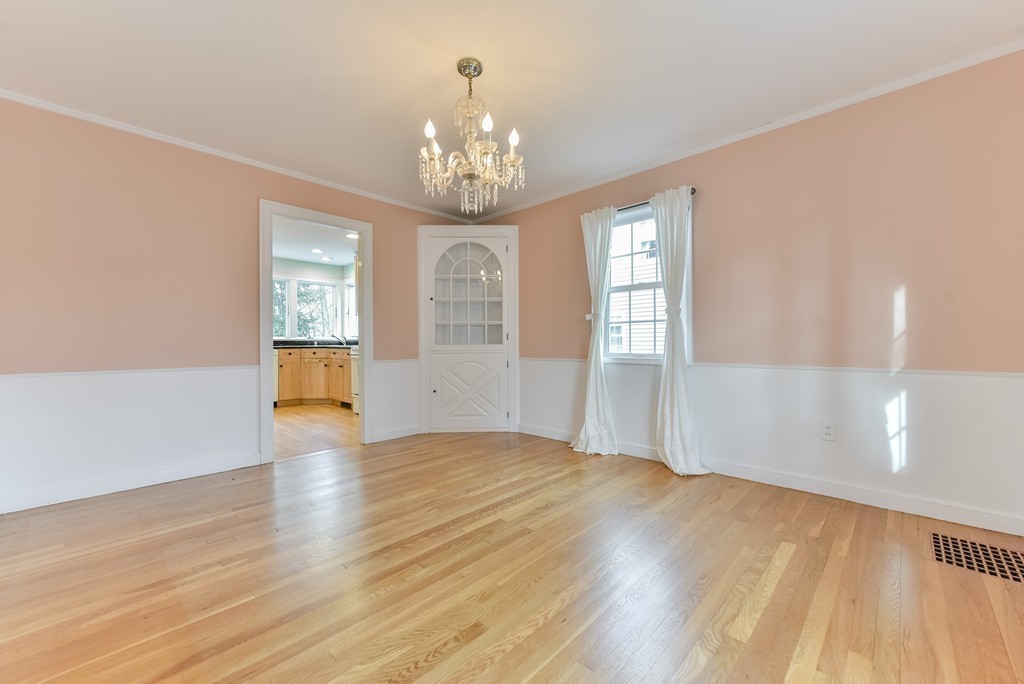 460 Brook Road Milton, MA 02186 - Photo 9 of 14 a view of an empty room with a window and wooden floor